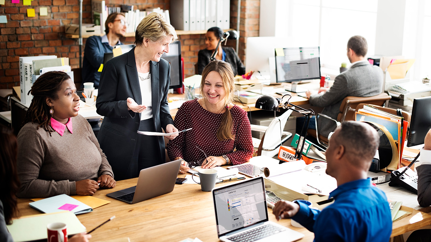 A group of insurance agents in a busy office environment
