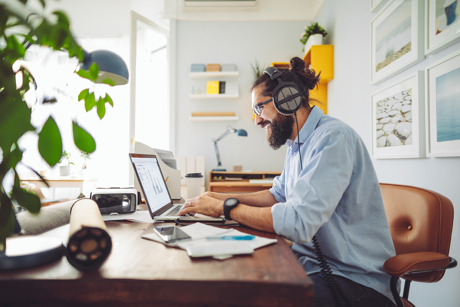 A CSAA emplopyee works remotely from their home office.