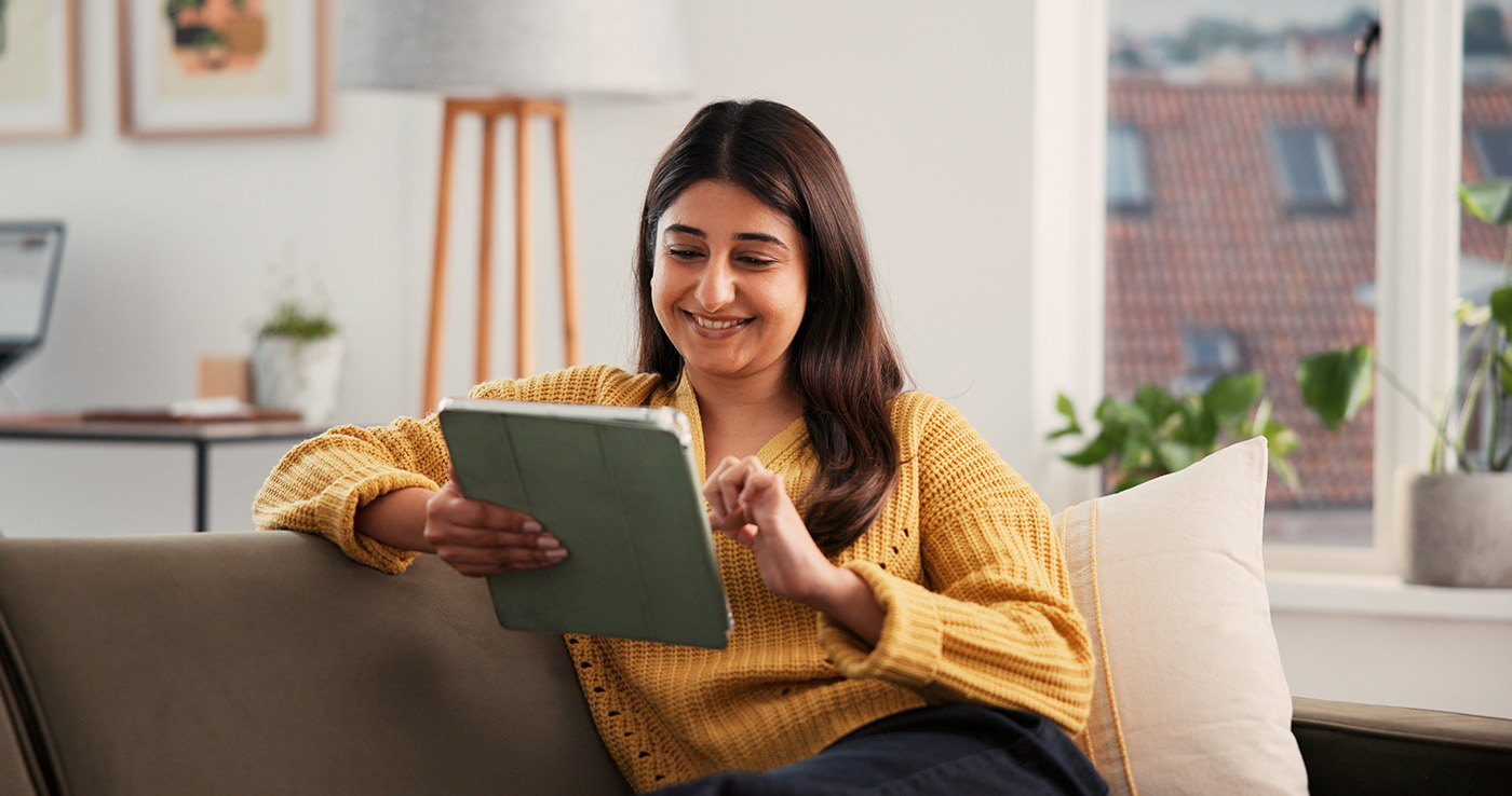 A CSAA insurance customer using MyPolicy to manage her insurance policy om a tablet