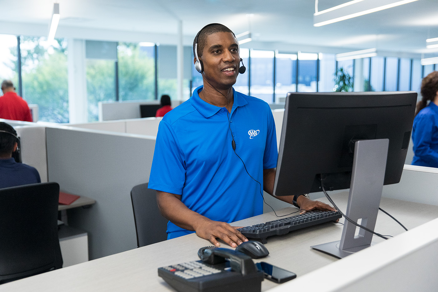 CSAA customer support representative speaking on the phone with a customer