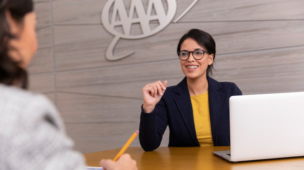 A female CSAA employee engaging in a meeting with colleagues at the office