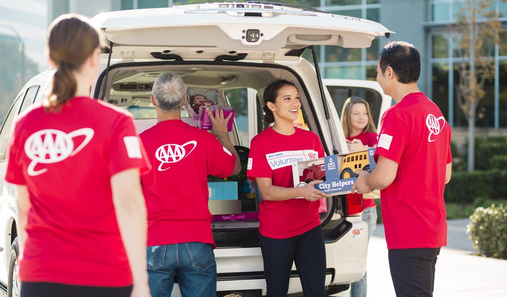 A group of CSAA employees in red shirts volunteering at a toy drive