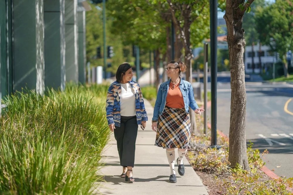 Two CSAA employees going for a walk outside their office