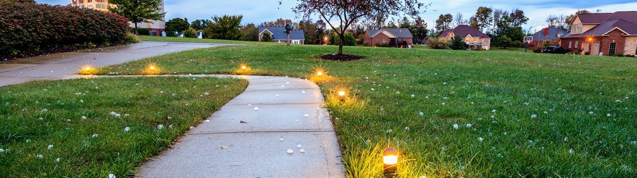 prepare for hailstorms, image of grass with hail in front of homes