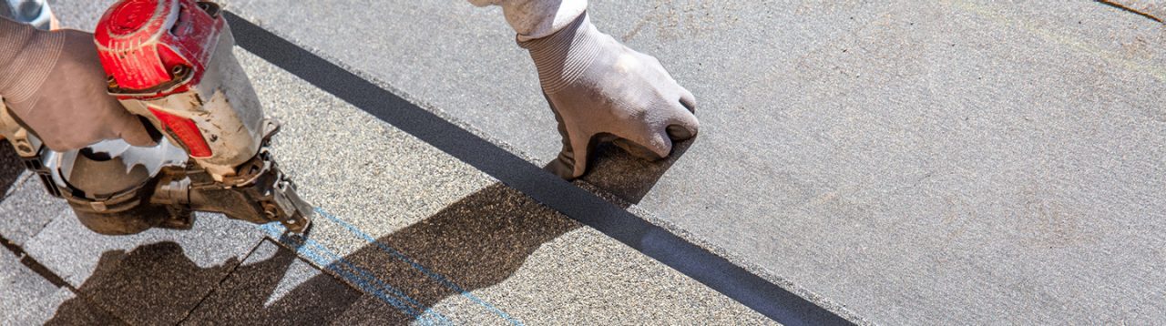 hands of a roofing contractor working on a roof